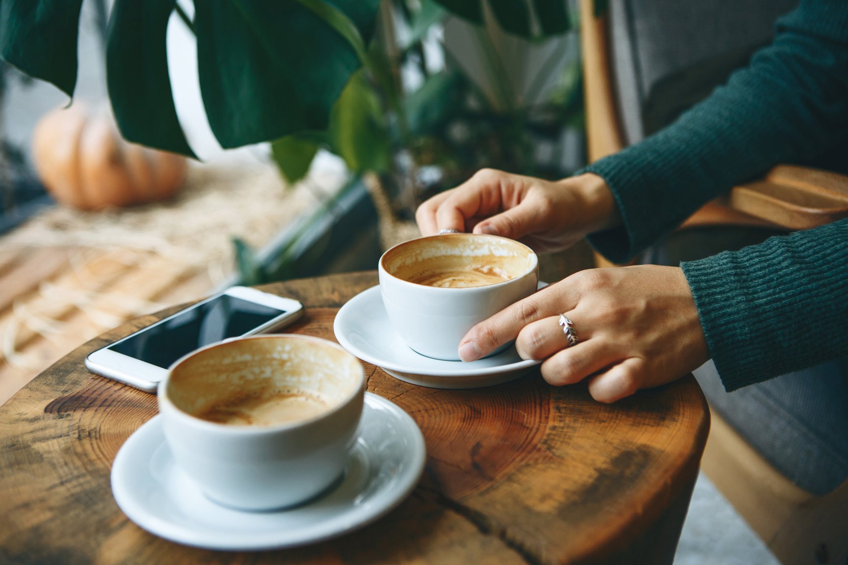 Girl drinks coffee during a meeting